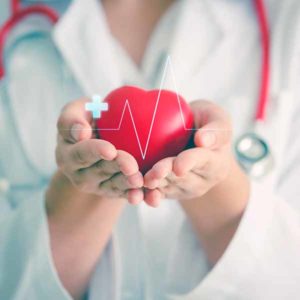 Female medical doctor holding red heart shape in hand with graphic of heart beat, cardiology and insurance concept