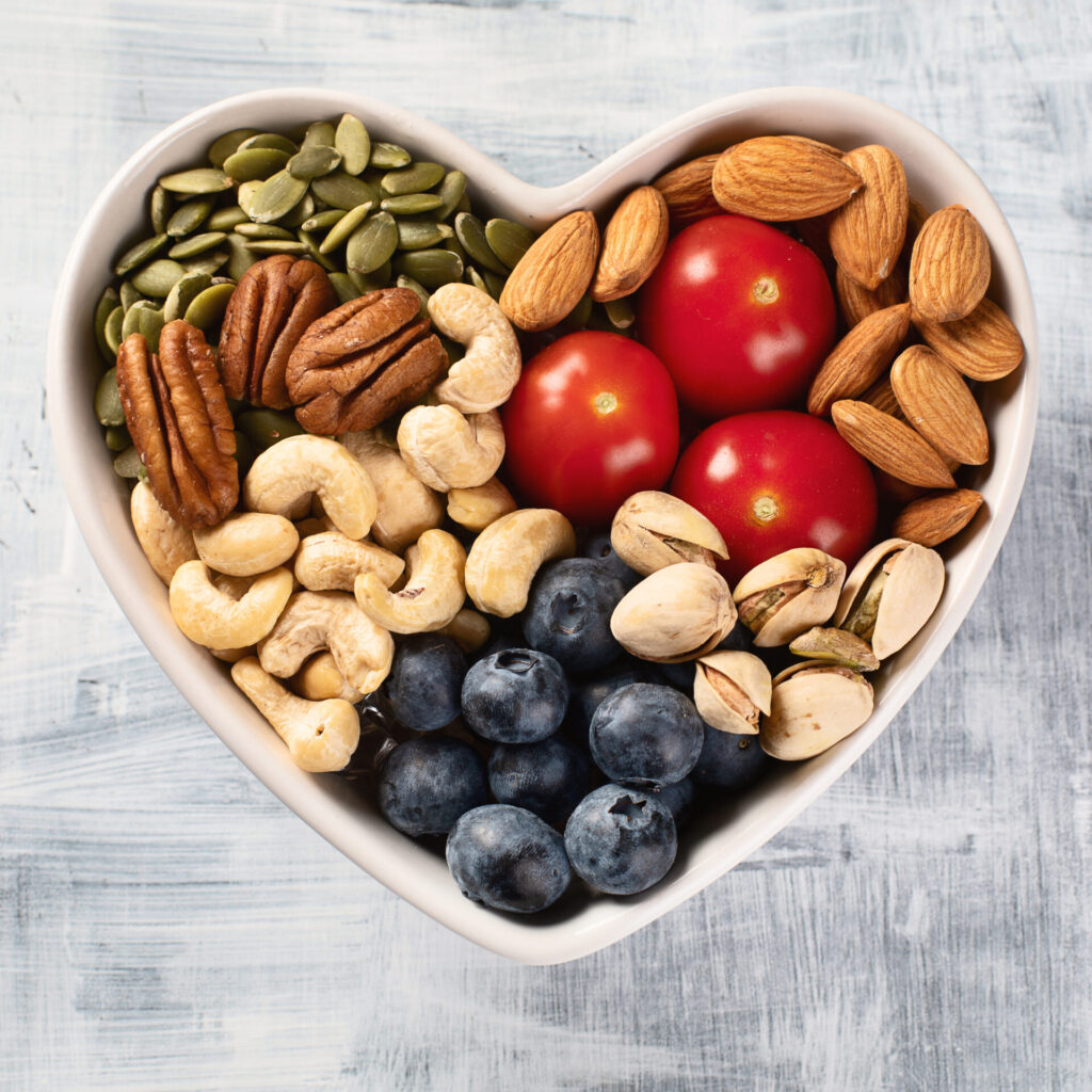 Healthy snack in heart shaped bowl. Top view